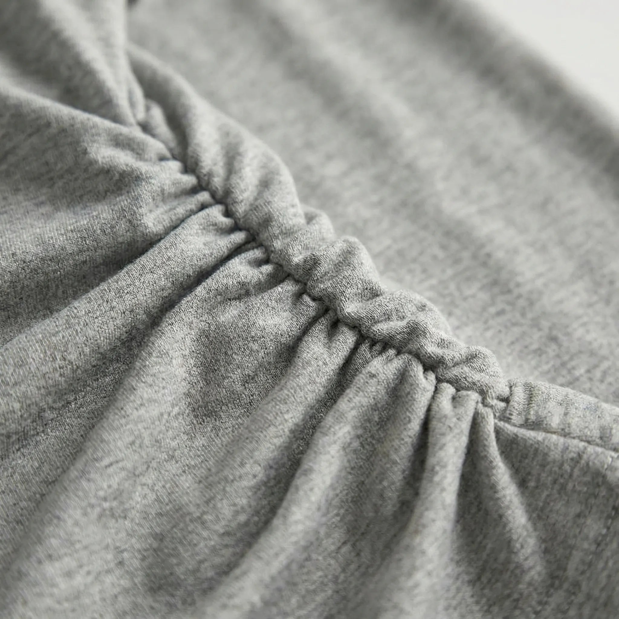 Close-up of dark gray fabric with a focus on texture and stitching2