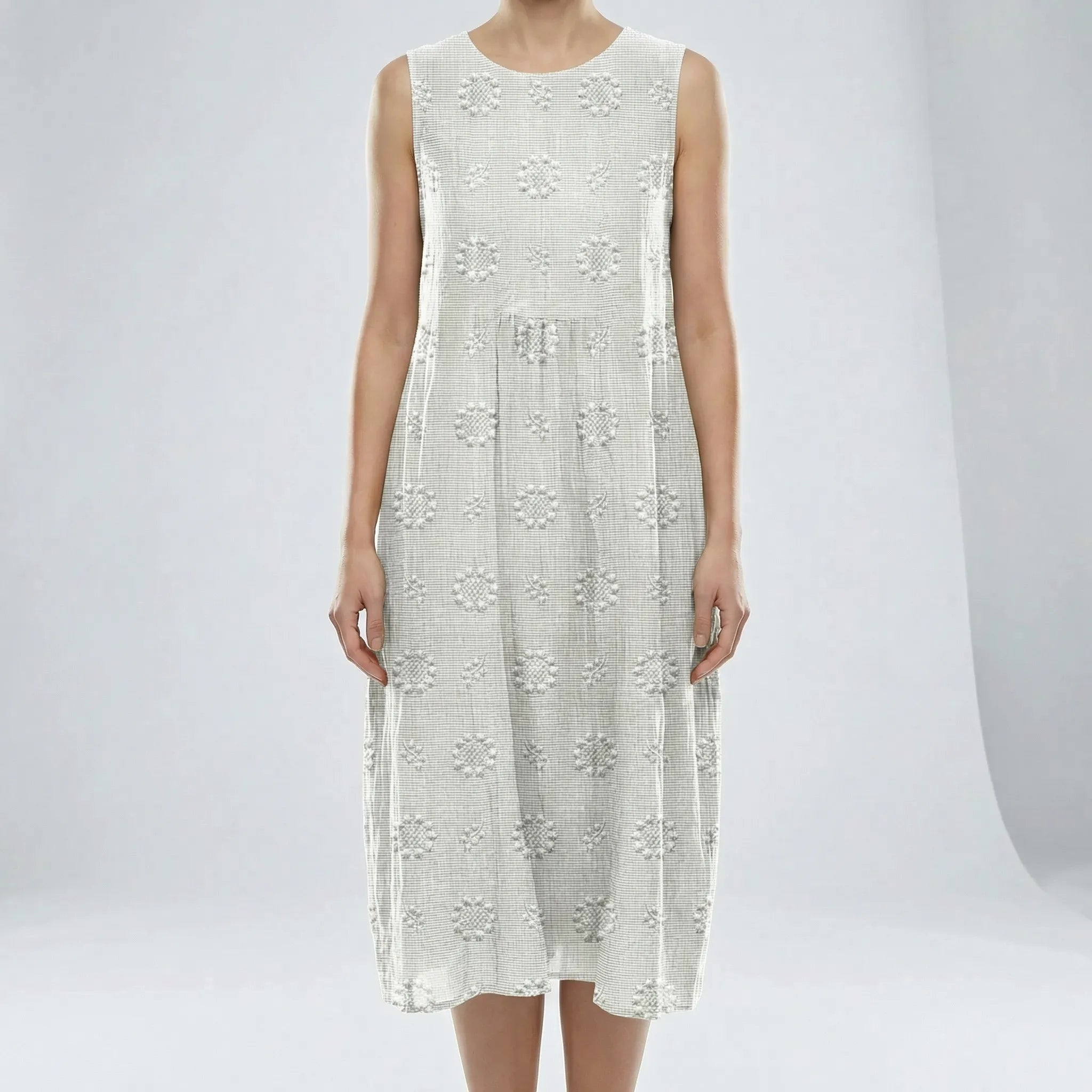 White sleeveless dress with floral patterns on a plain background