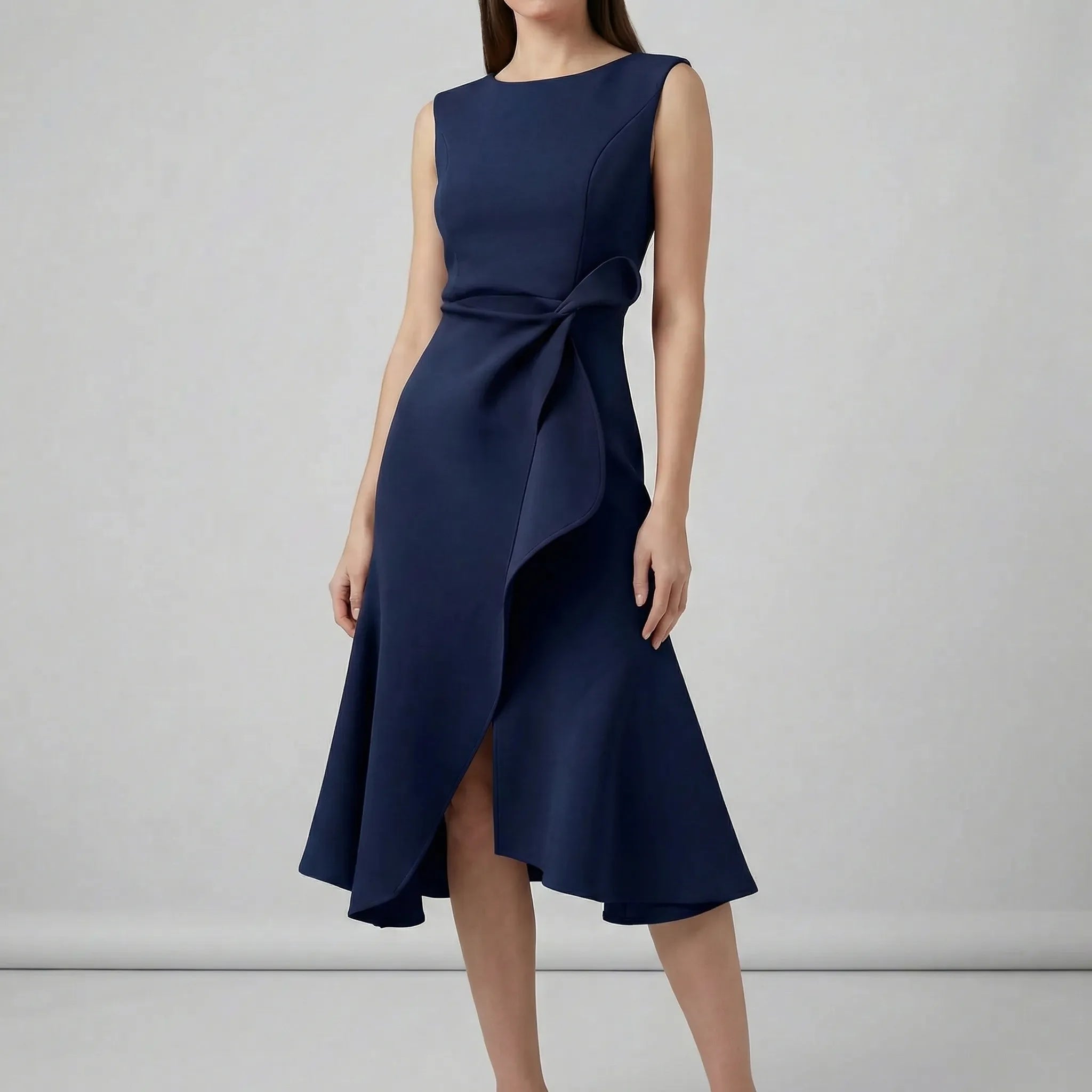 Navy blue dress with a bow detail on a gray background