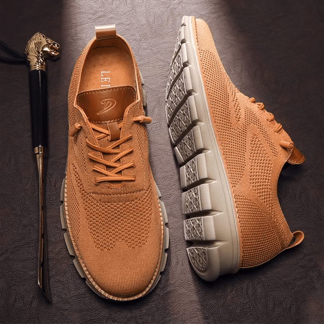 Brown sneakers with a walking cane on a dark surface