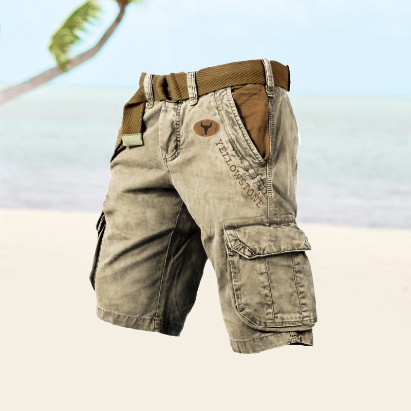 Beige cargo shorts with a brown belt on a blurred natural background