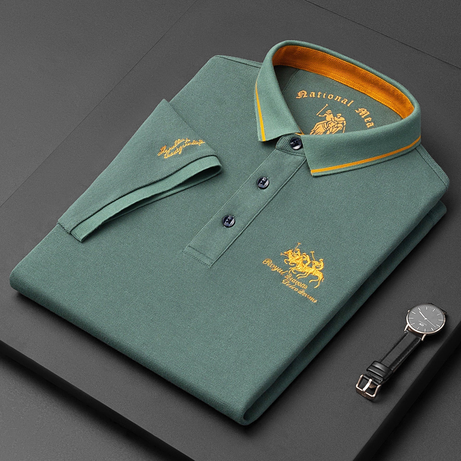 Green polo shirt with gold accents on a dark surface