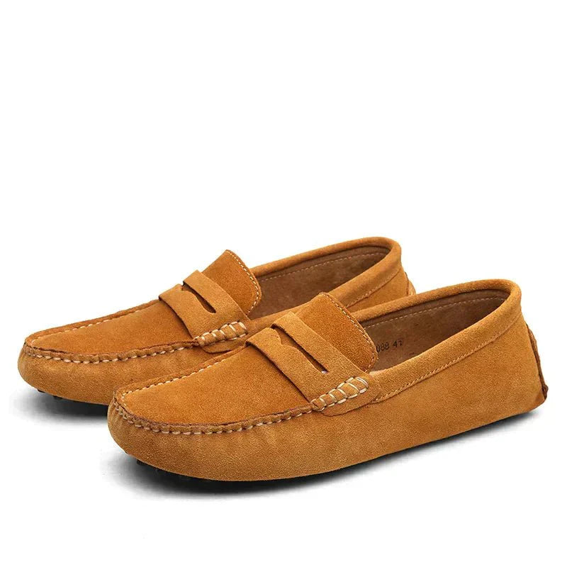 Pair of brown suede loafers on a white background