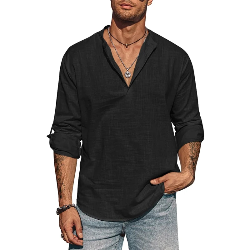Man wearing a black long-sleeve shirt with rolled-up sleeves on a white background