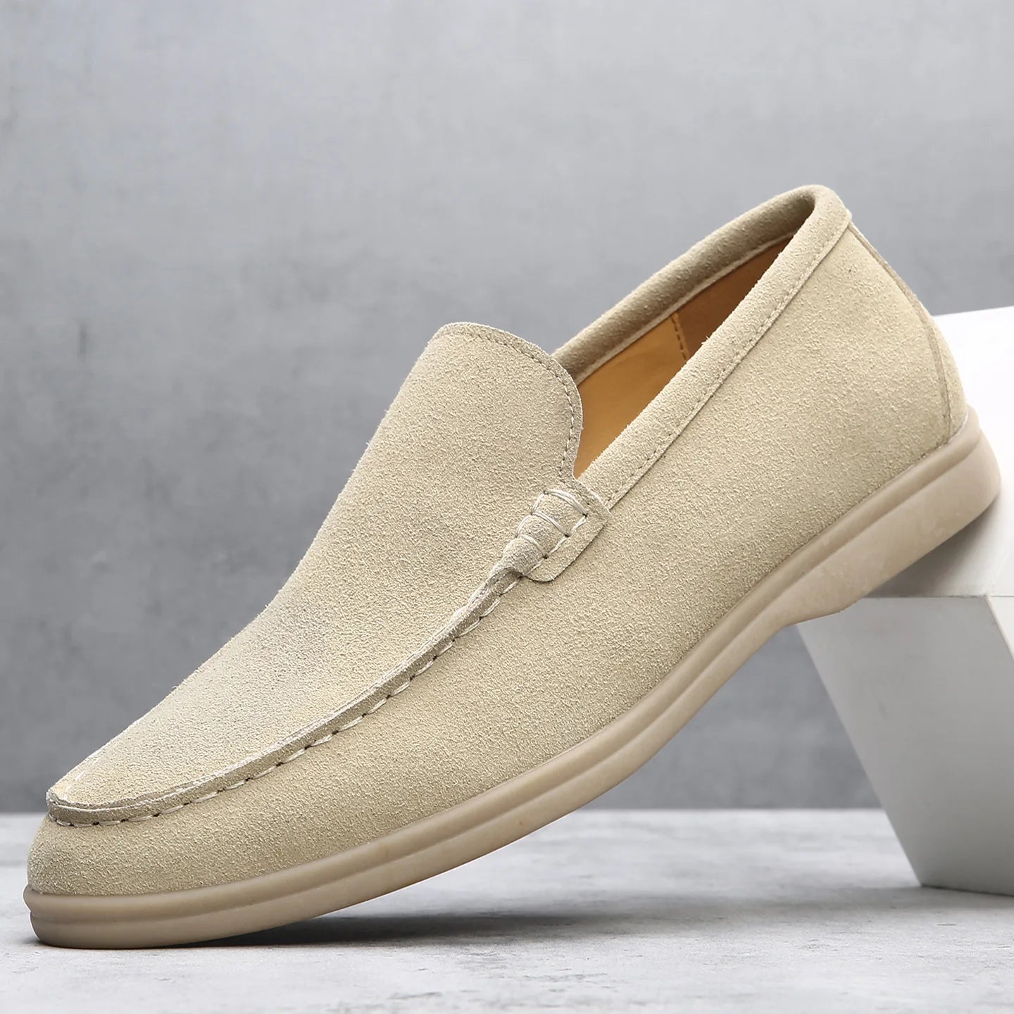 Beige loafer shoe on a light gray background