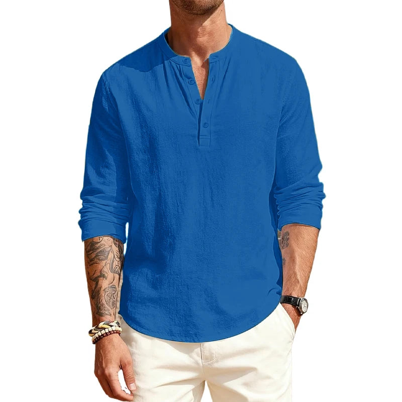 Man wearing a blue long-sleeve shirt and white pants on a white background