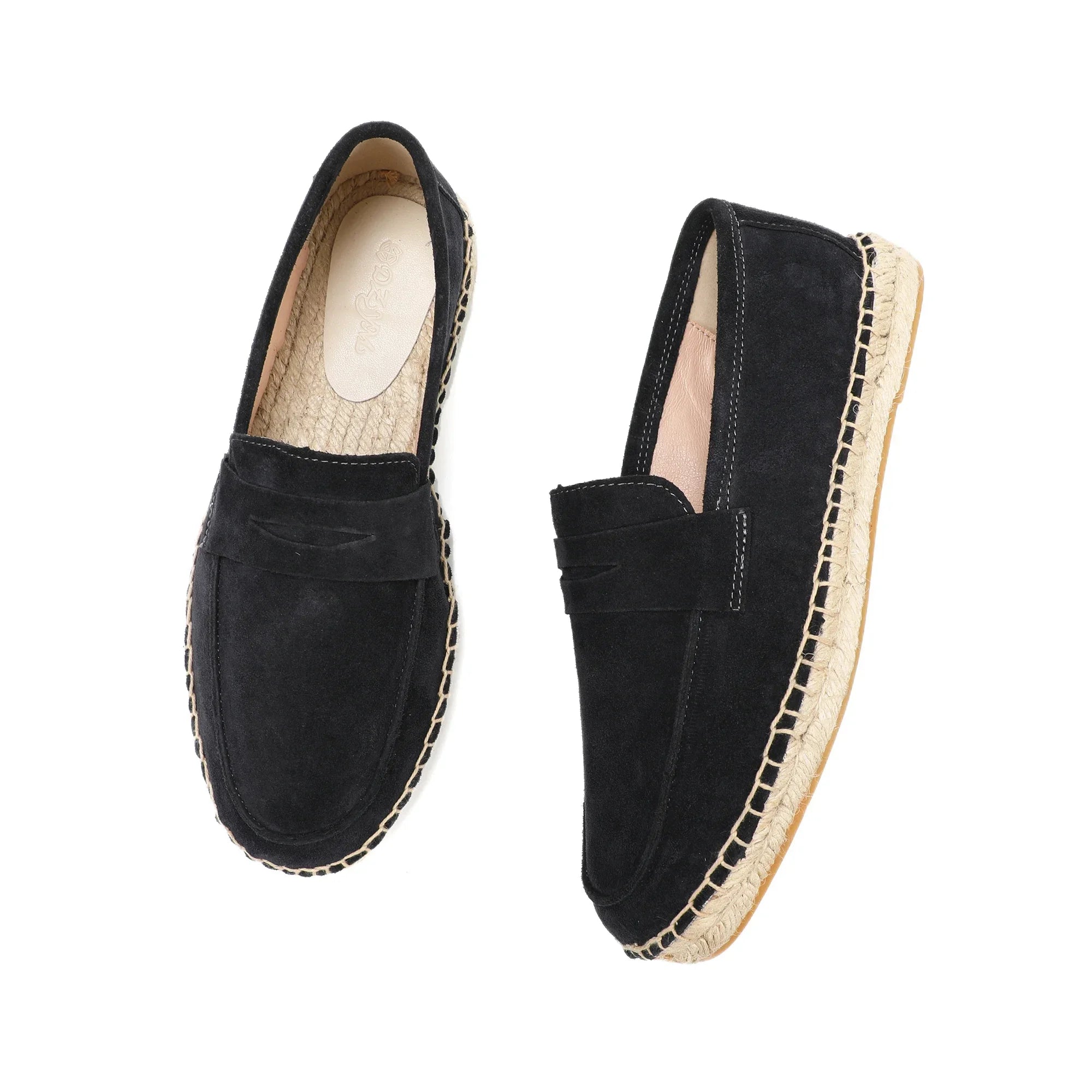 Pair of black espadrille loafers on a white background