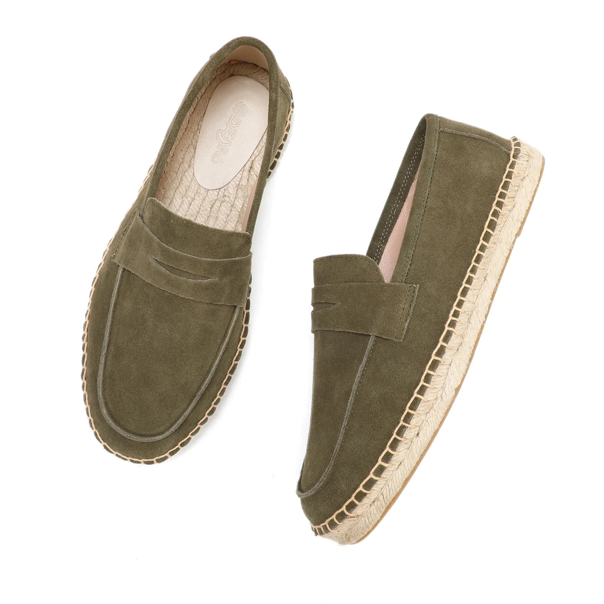 Pair of green suede espadrilles on a white background