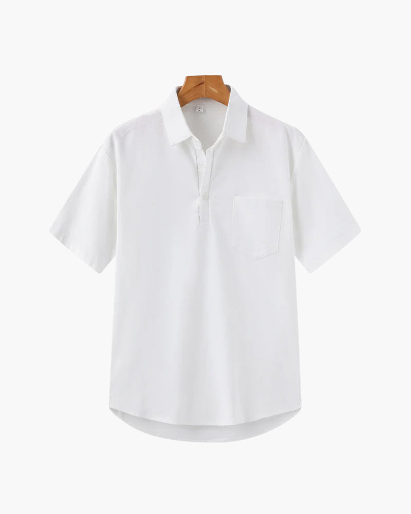White shirt on a wooden hanger against a white background