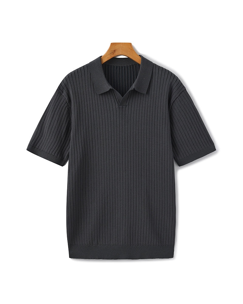 Black ribbed polo shirt on a hanger against a white background