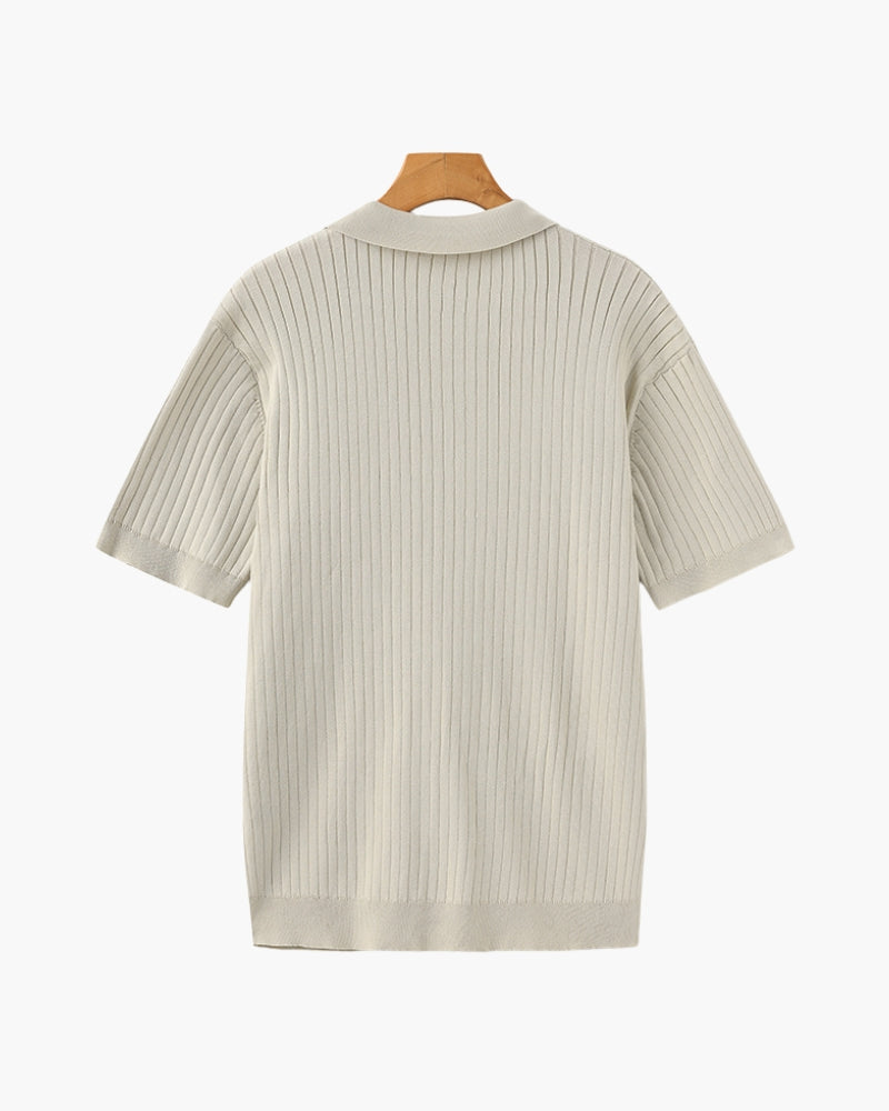 Beige ribbed knit dress on a hanger against a white background
