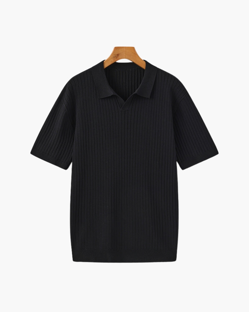 Black ribbed polo shirt on a hanger against a white background