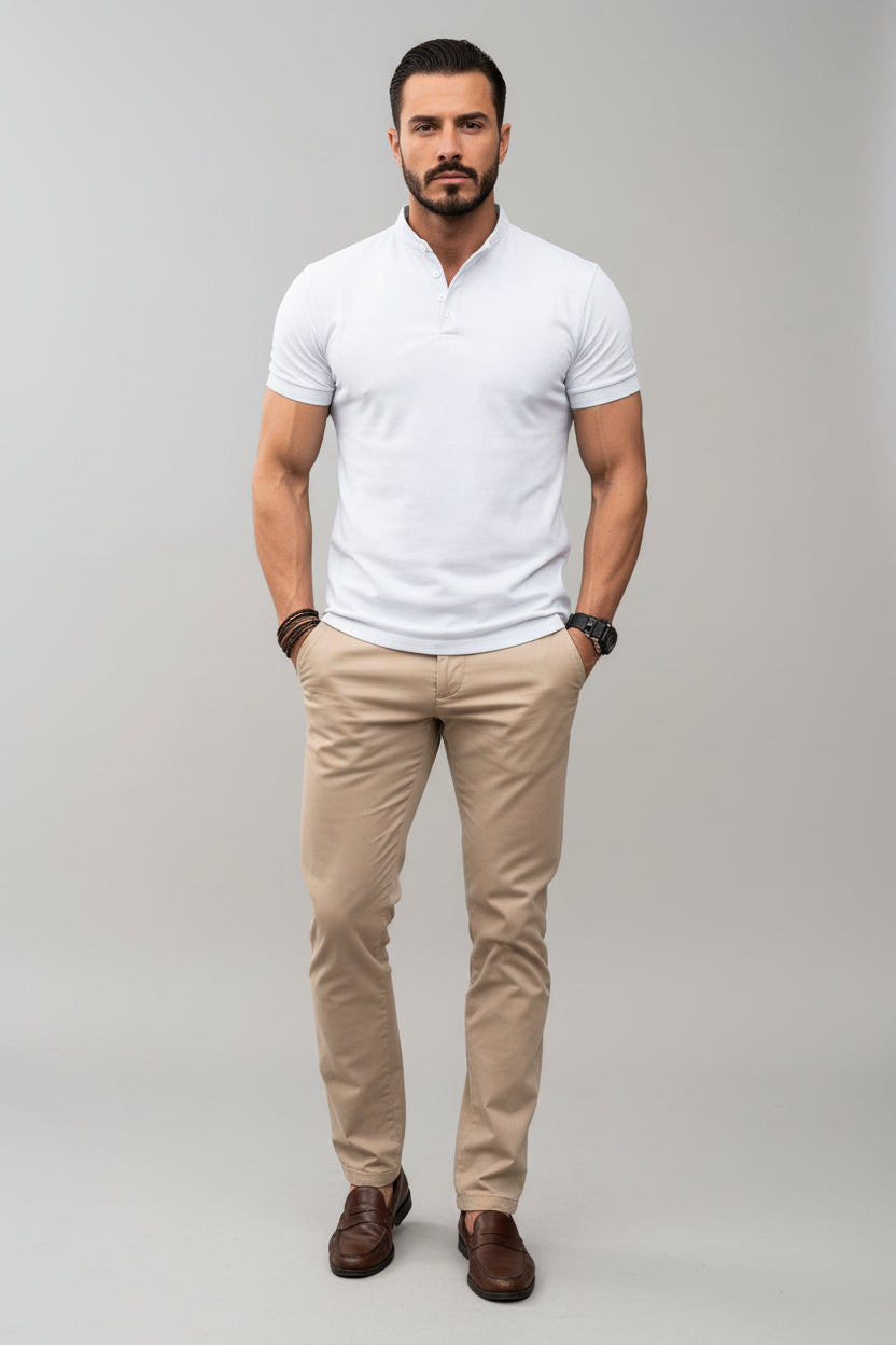 Man wearing a white polo shirt and beige pants against a gray background