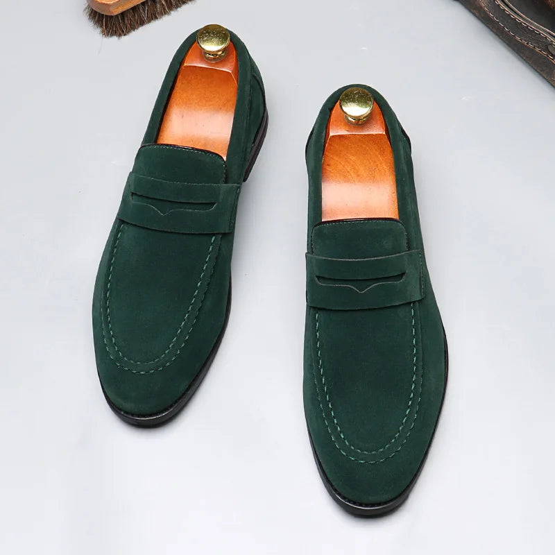 Pair of green loafers on a light gray background
