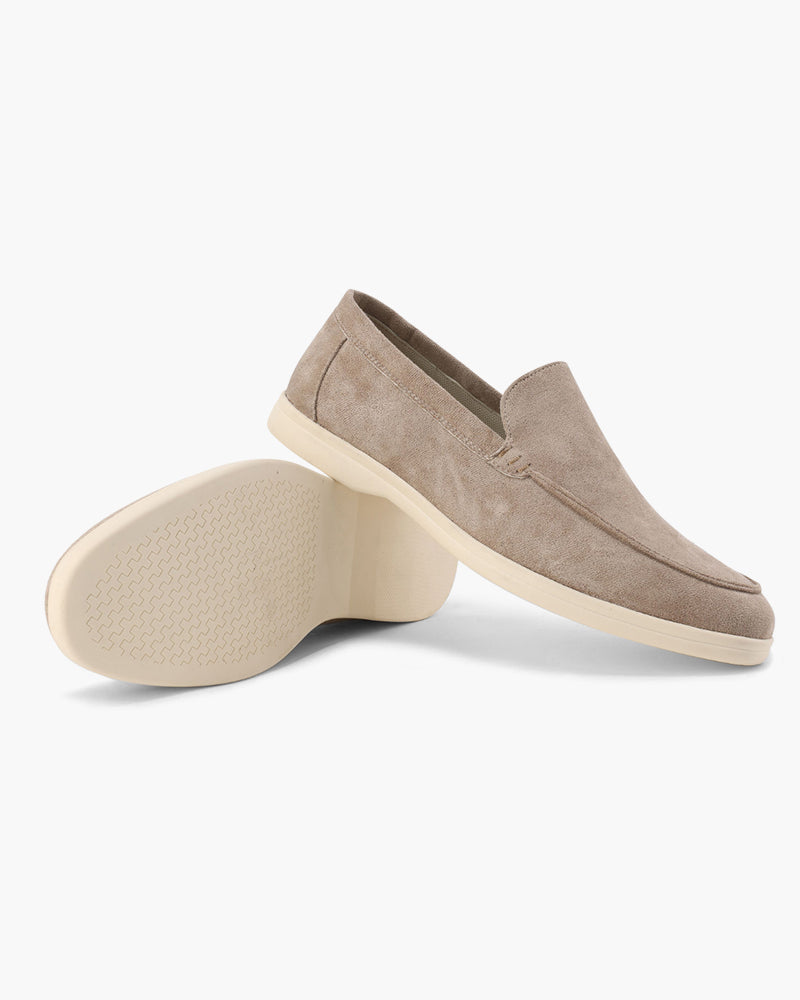 Beige loafers on a white background