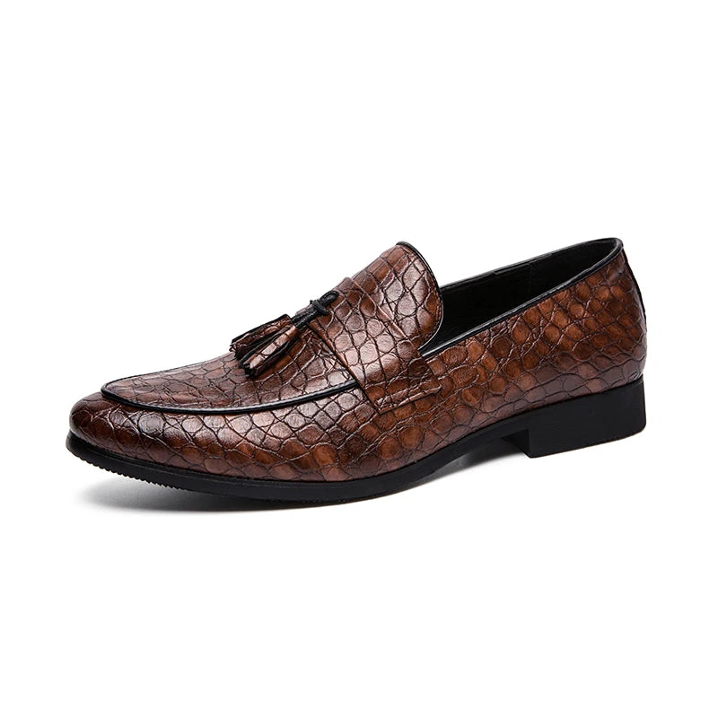Brown leather loafer with tassel on a white background