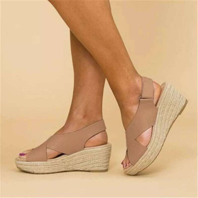 Beige wedge sandals on a beige background