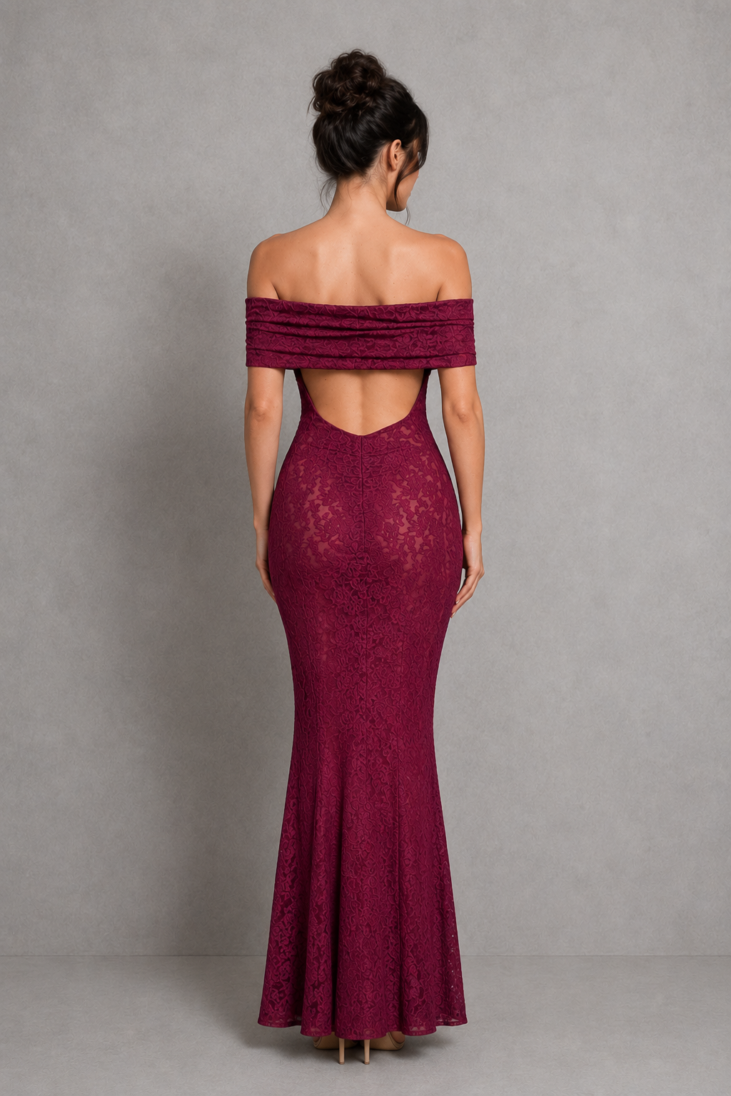 Woman wearing a burgundy off-shoulder lace dress against a gray background