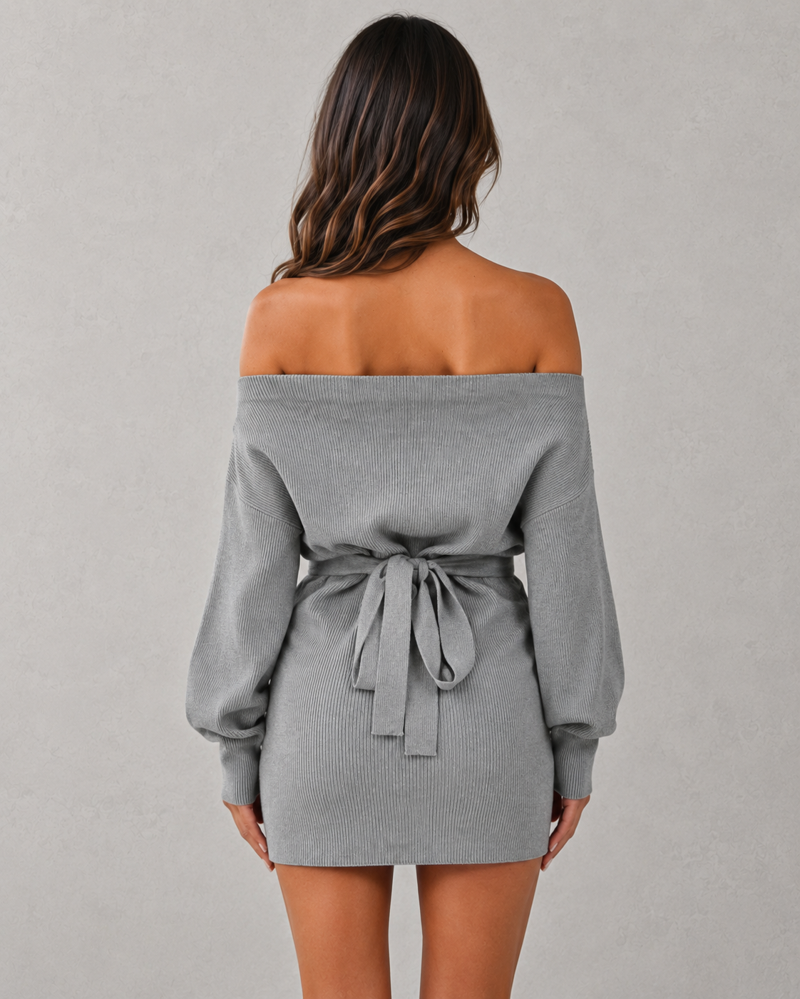 Gray off-shoulder dress with a belt on a plain background