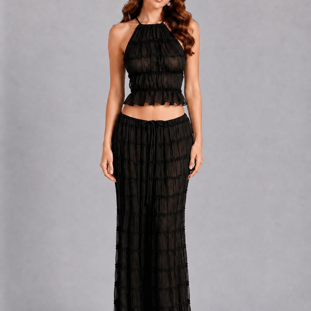 Woman wearing a black dress against a gray background