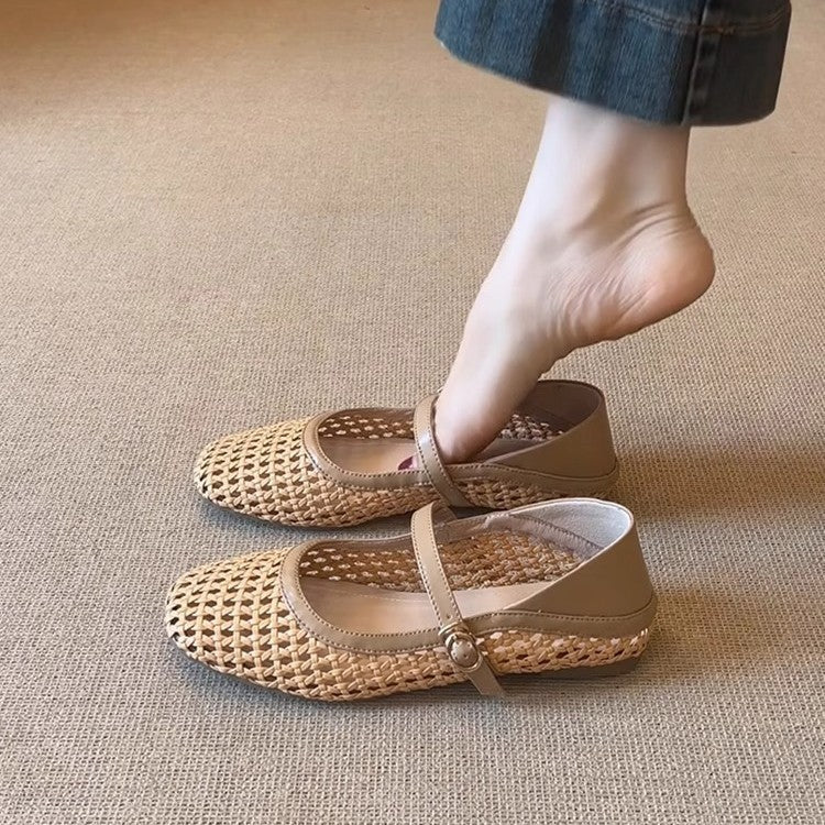 Beige woven shoes worn by a person on a beige carpet