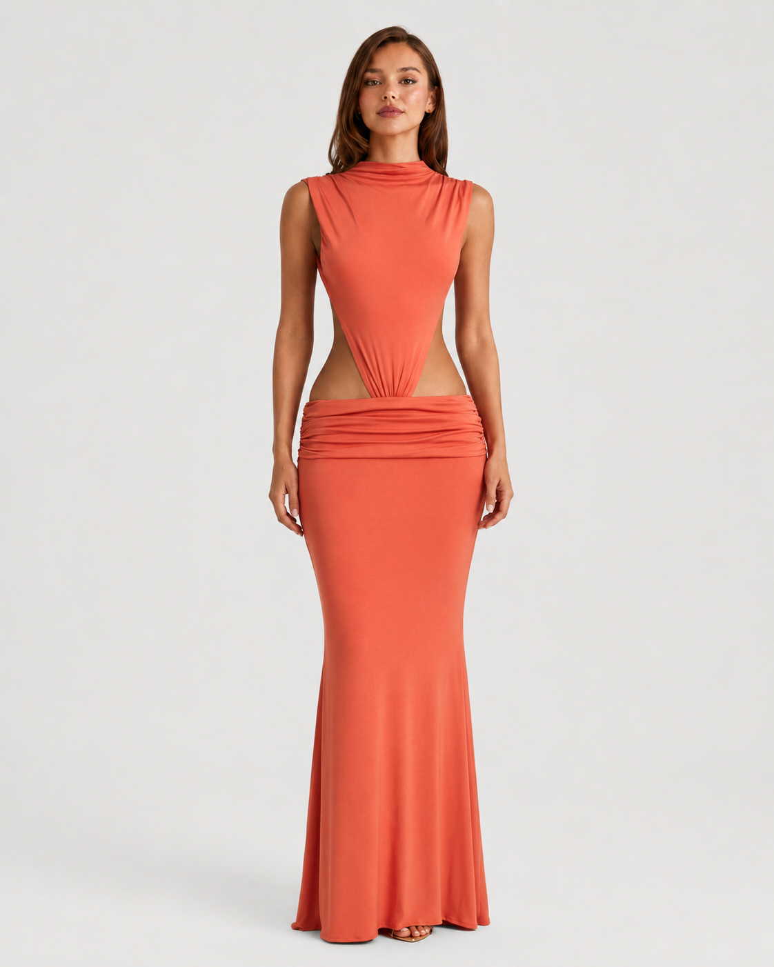Woman wearing a coral dress with cut-out design on a white background