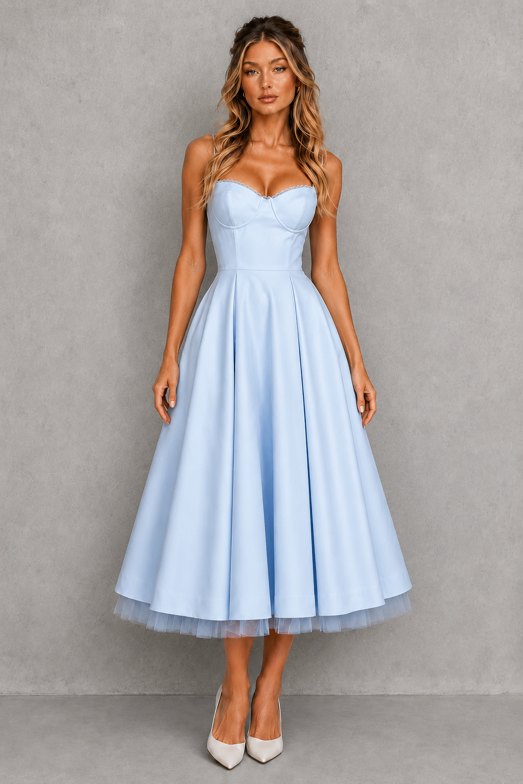 Woman wearing a light blue strapless dress against a gray background