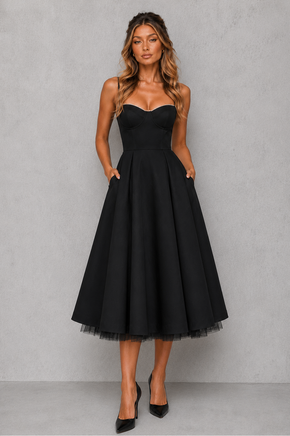 Woman wearing a black dress against a gray background