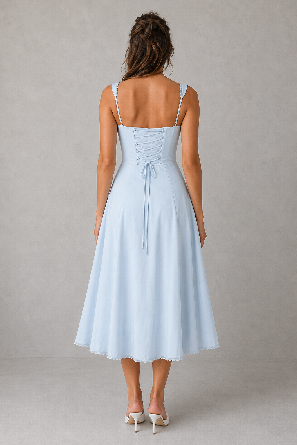 Light blue dress with thin straps on a gray background