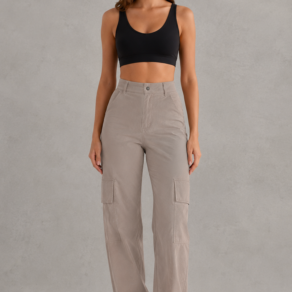 Woman wearing beige cargo pants and a black top on a gray background