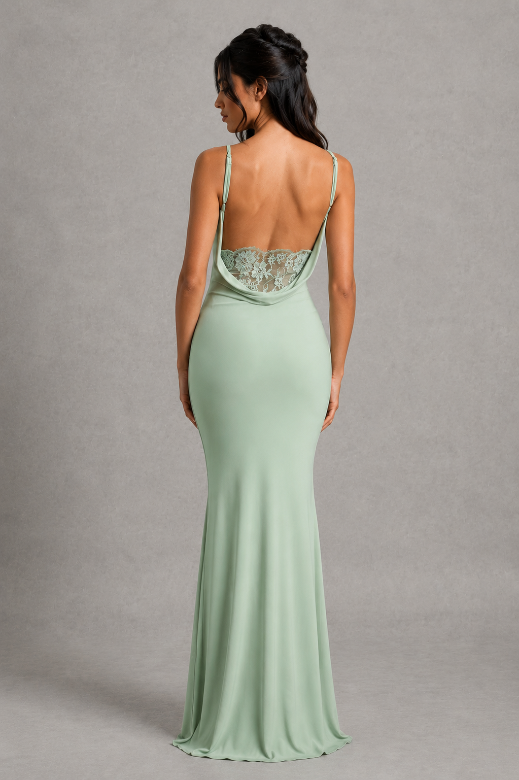 Woman wearing a green evening gown with a gray background
