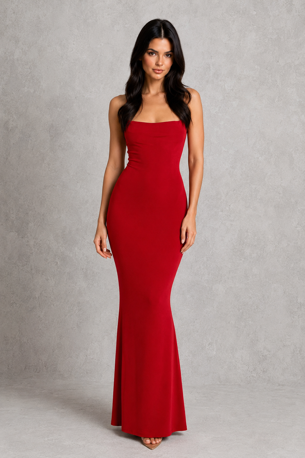 Woman wearing a red strapless gown against a gray background