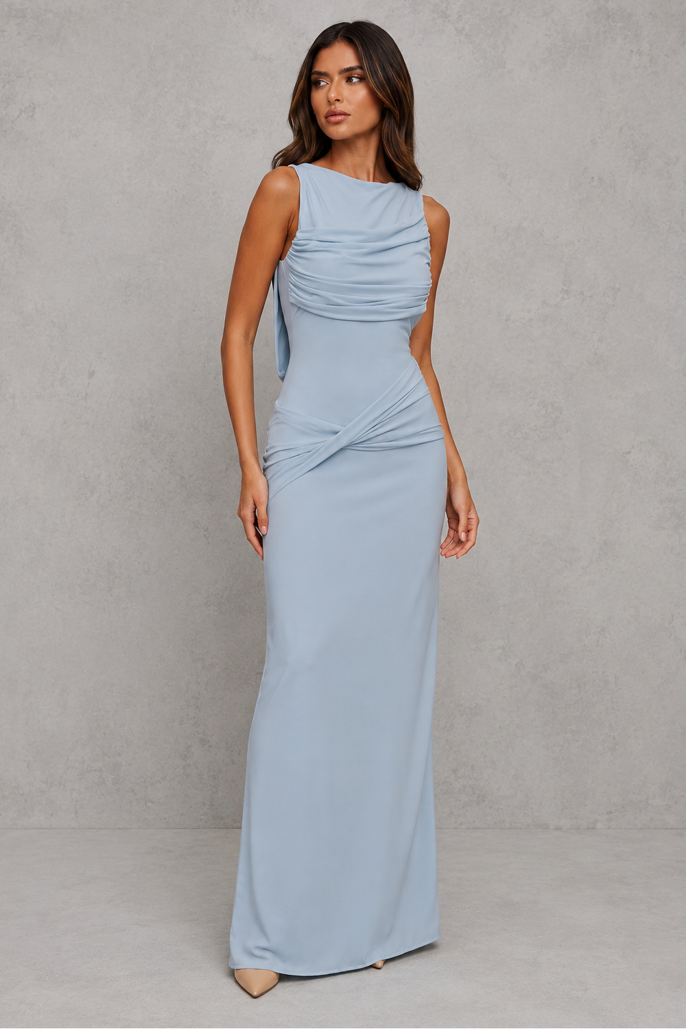Woman wearing a light blue gown against a gray background