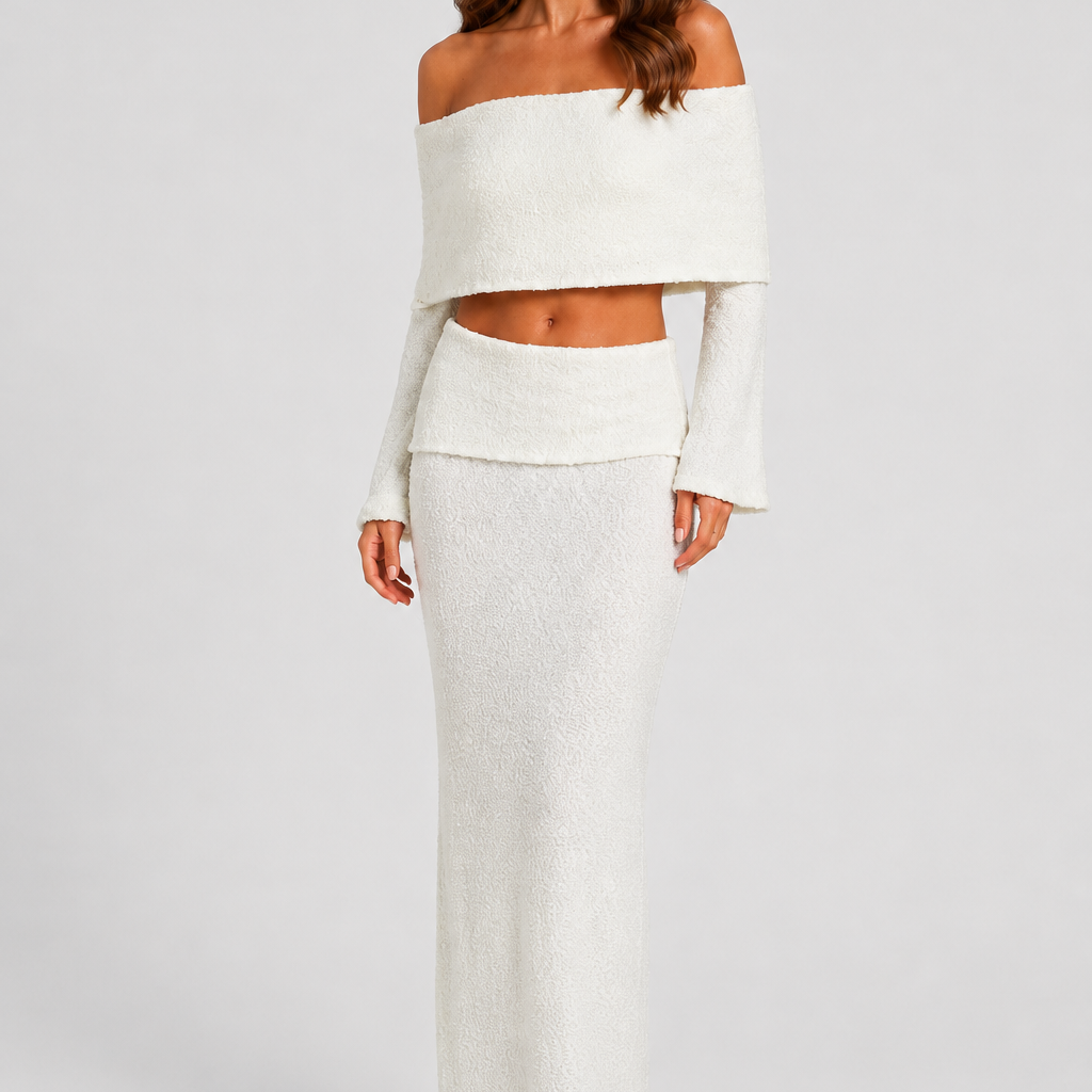 Woman wearing a white off-shoulder top and skirt set against a plain background