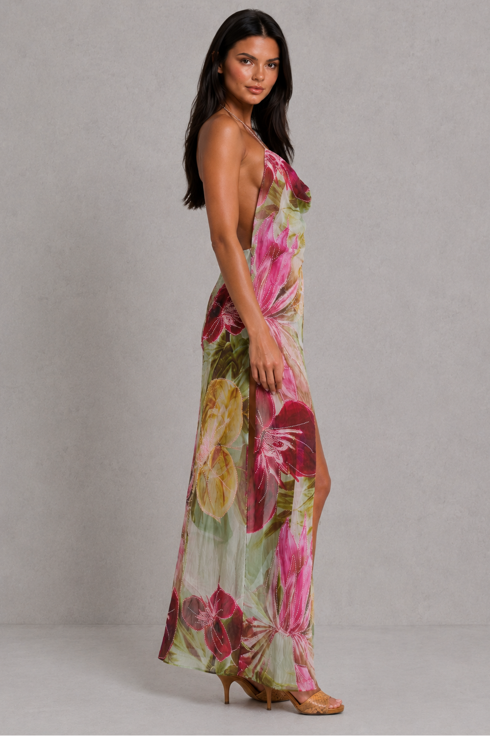 Woman wearing a floral dress against a plain background