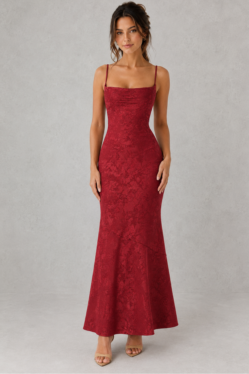 Woman wearing a red lace dress against a gray background