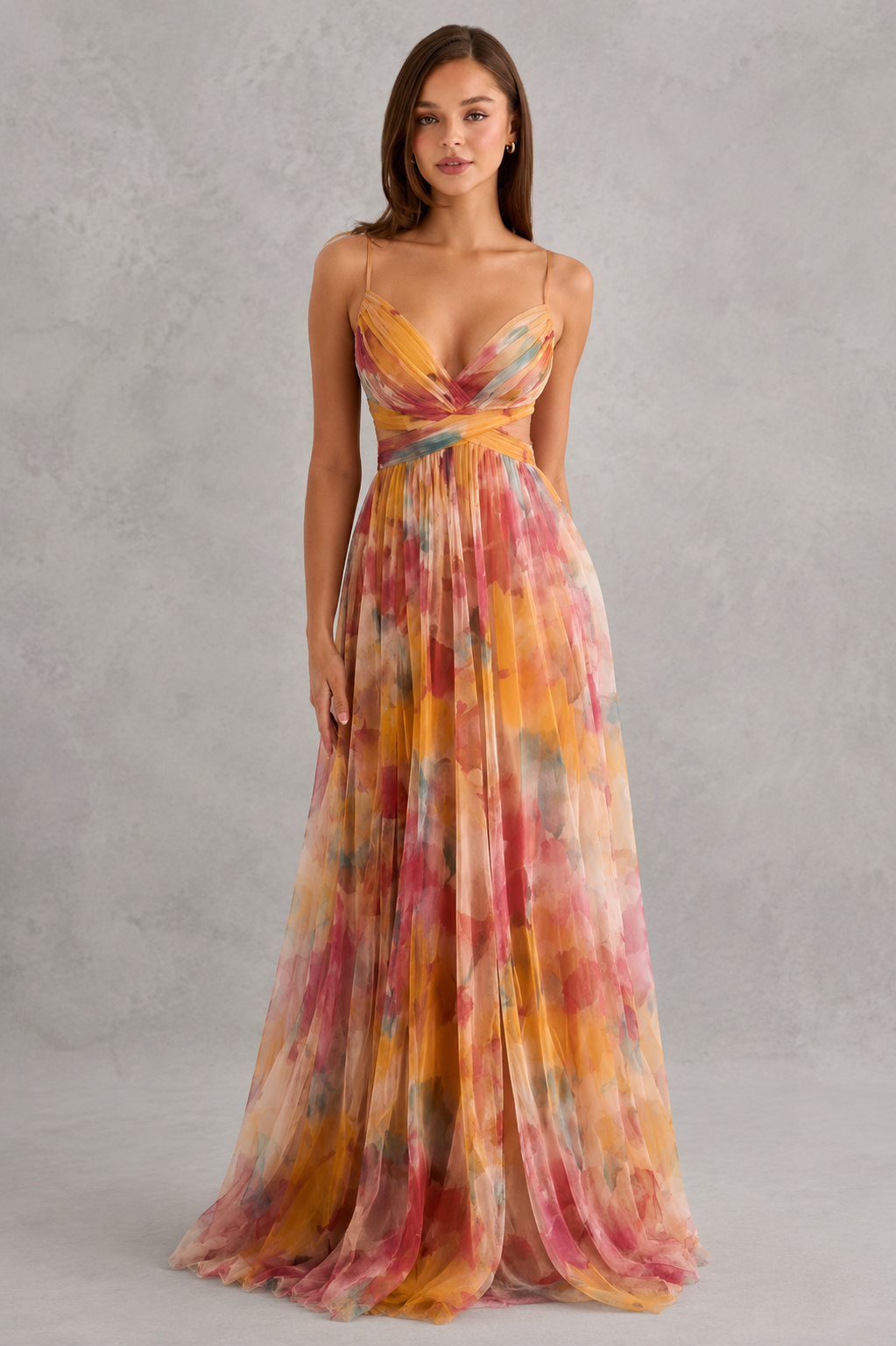 Woman wearing a colorful floral dress against a gray background