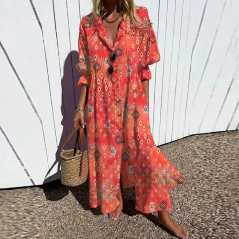 Person wearing a red patterned dress holding a straw bag against a white wall.