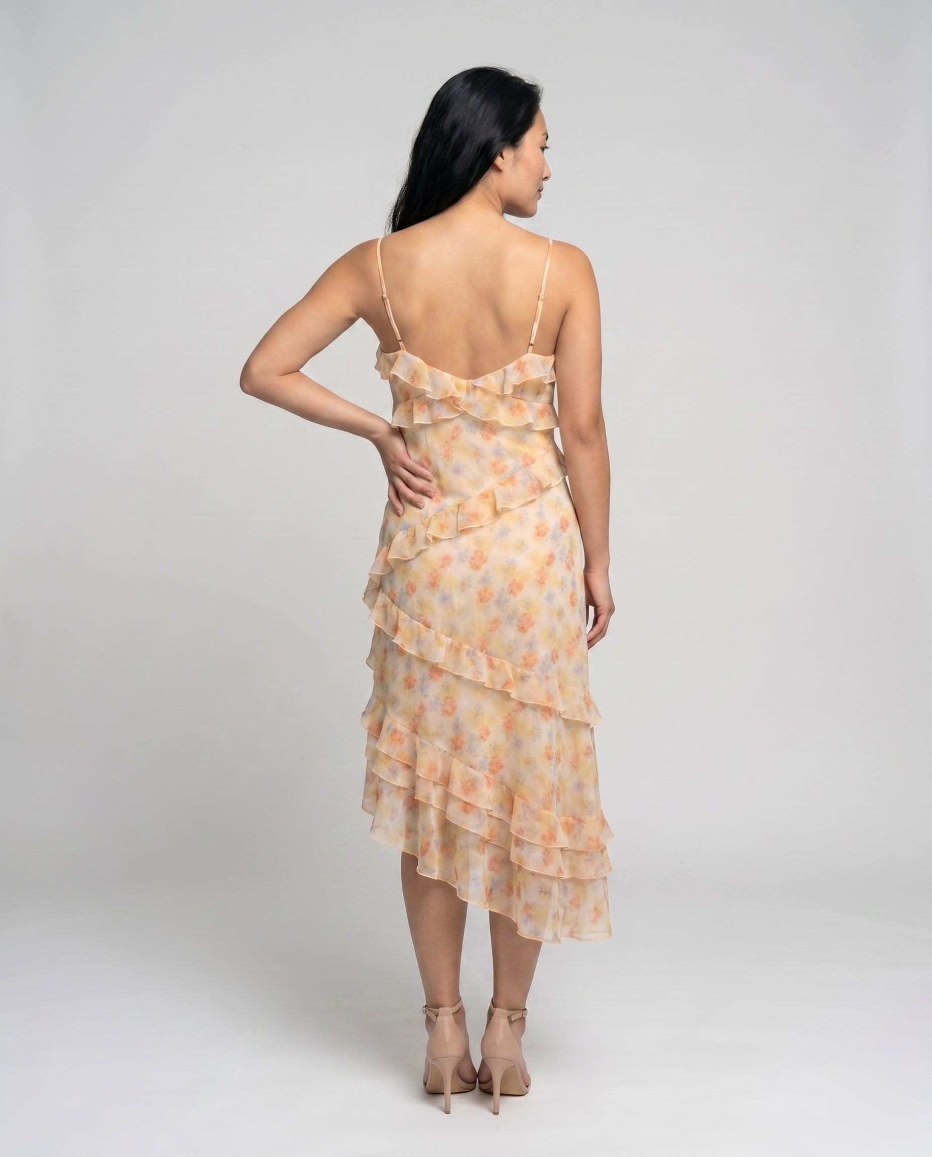 Woman wearing a floral dress on a plain background