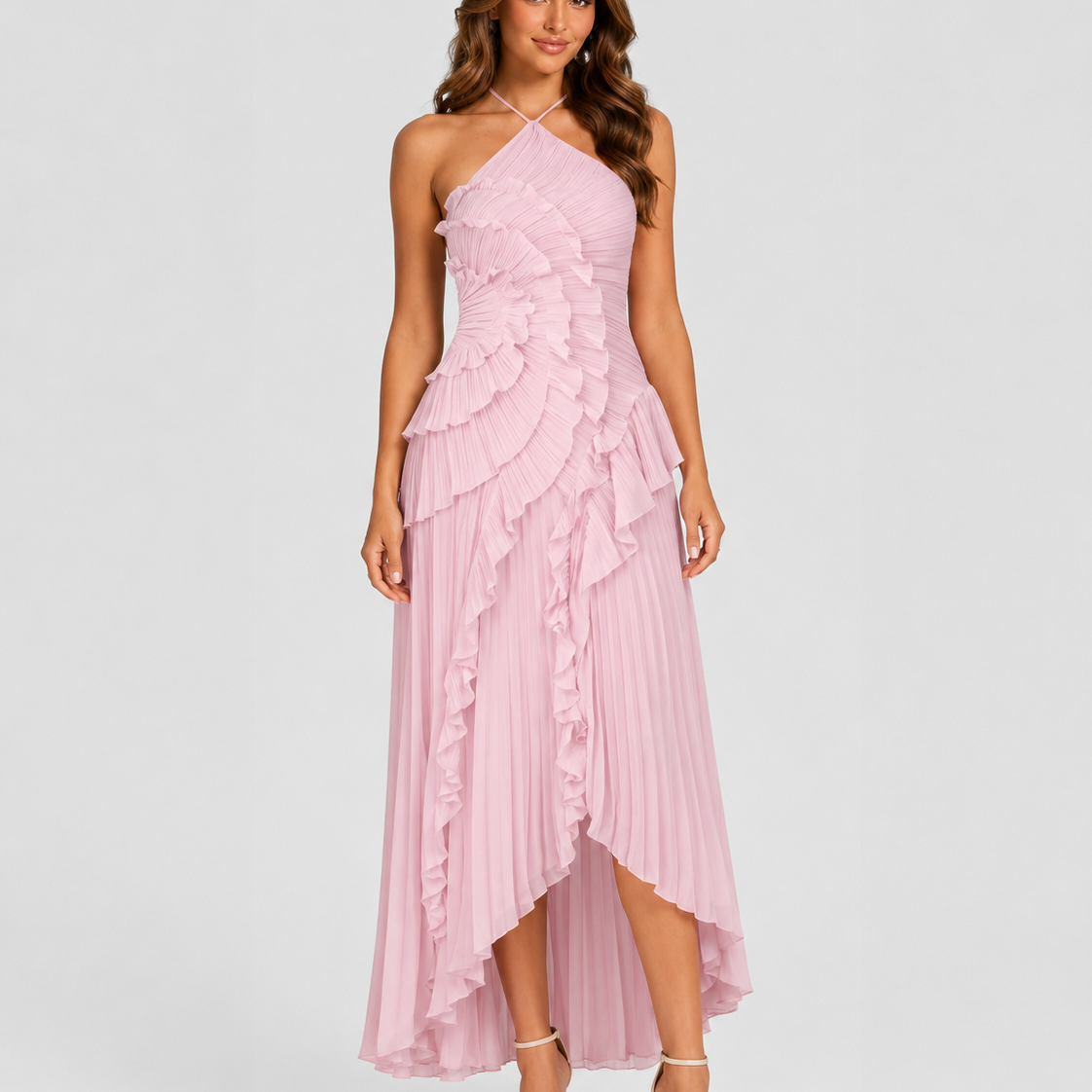 Woman wearing a pink one-shoulder dress with ruffled layers on a white background