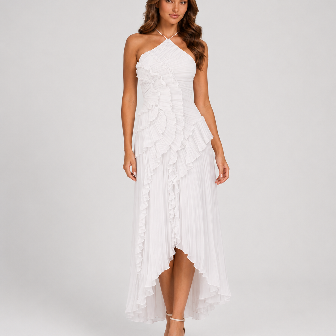 Woman wearing a white halter neck dress with floral details on a white background