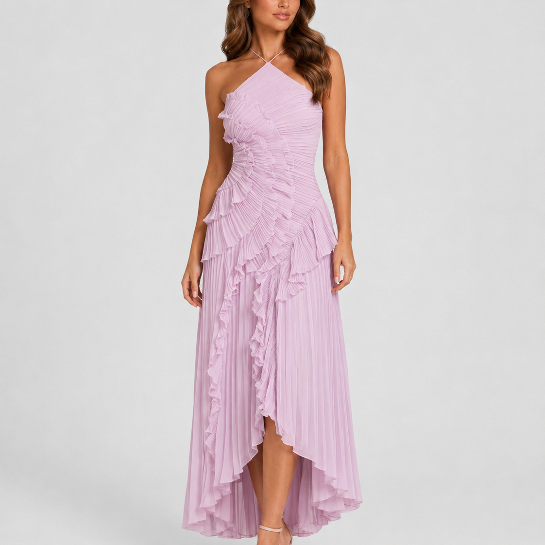 Woman wearing a lilac halter neck dress with ruffled layers on a white background