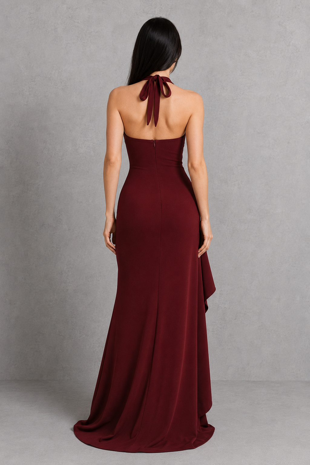 Burgundy halter neck gown on a gray background