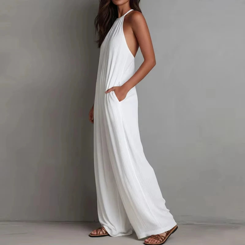 Woman wearing a white dress against a gray background