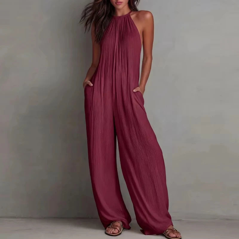 Maroon jumpsuit worn by a model against a neutral background