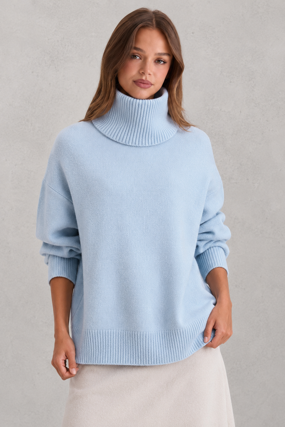 Woman wearing a light blue turtleneck sweater against a plain background