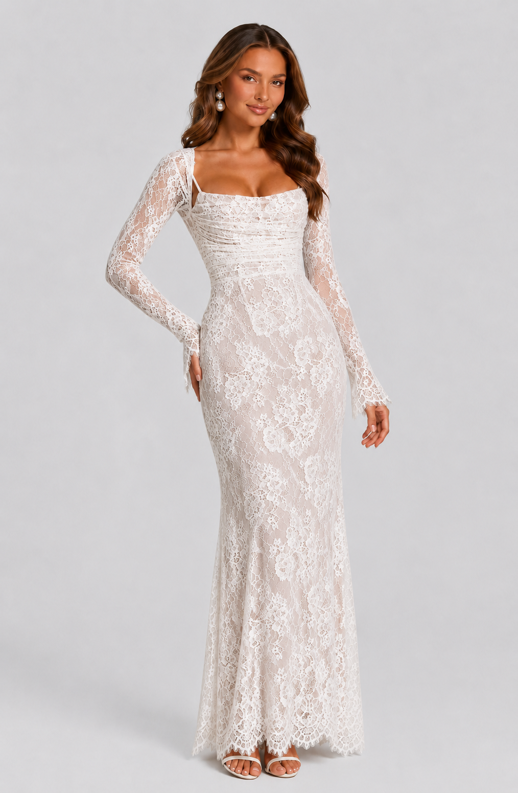 Woman wearing a white lace dress on a gray background