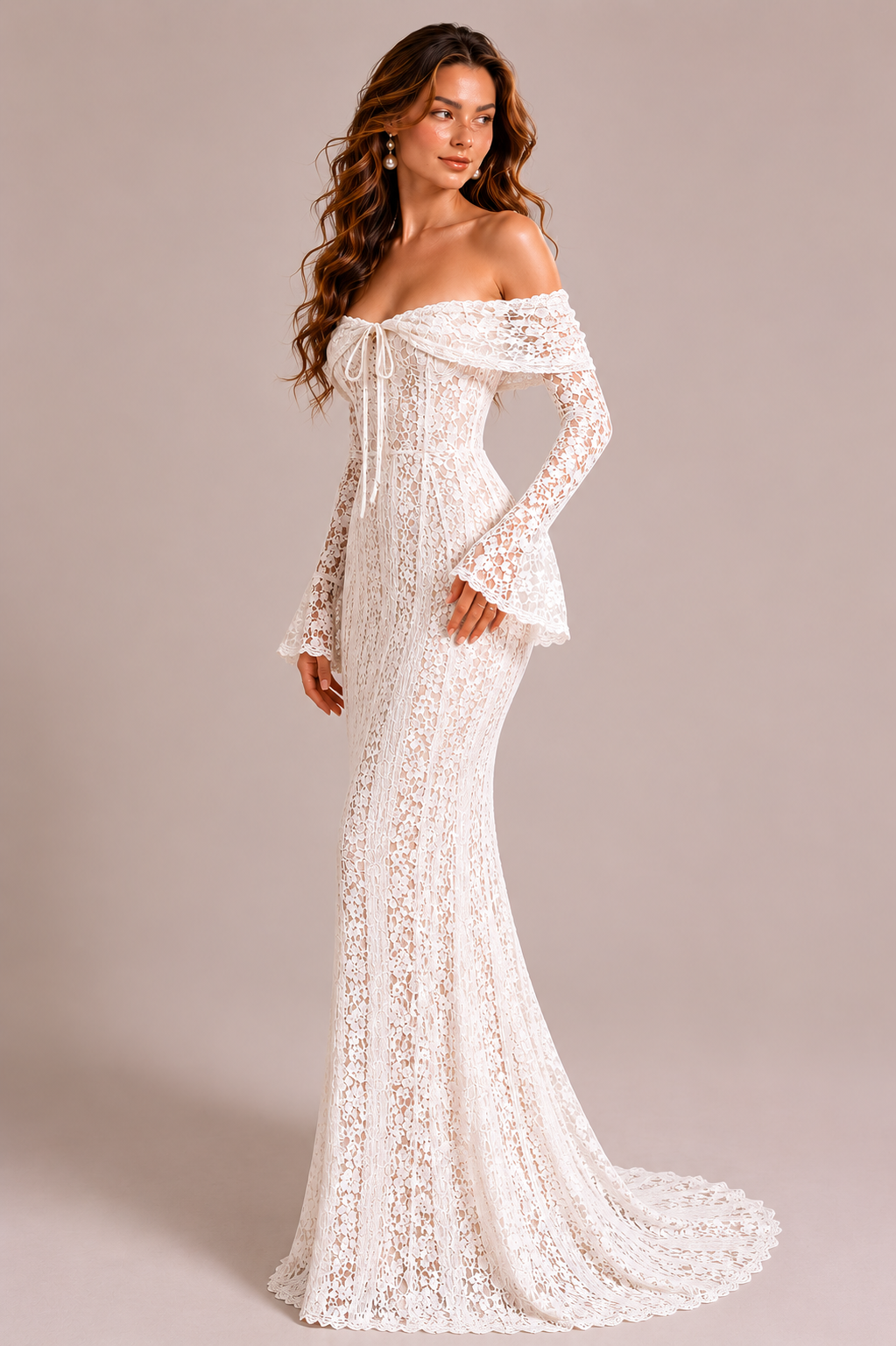 Woman wearing a white lace off-shoulder gown against a neutral background