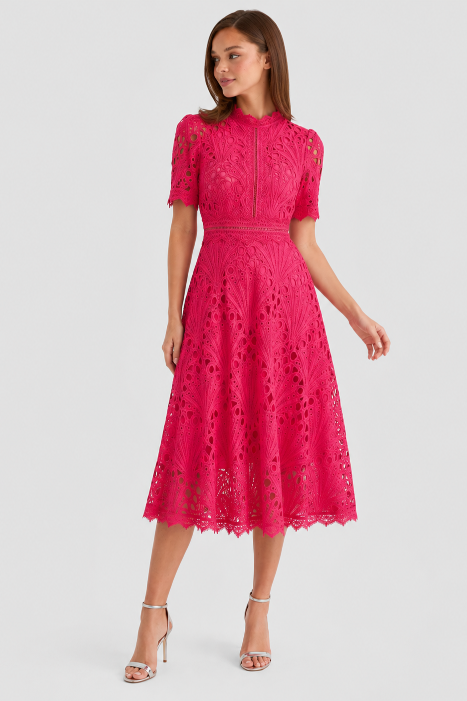 Woman wearing a pink lace dress on a white background