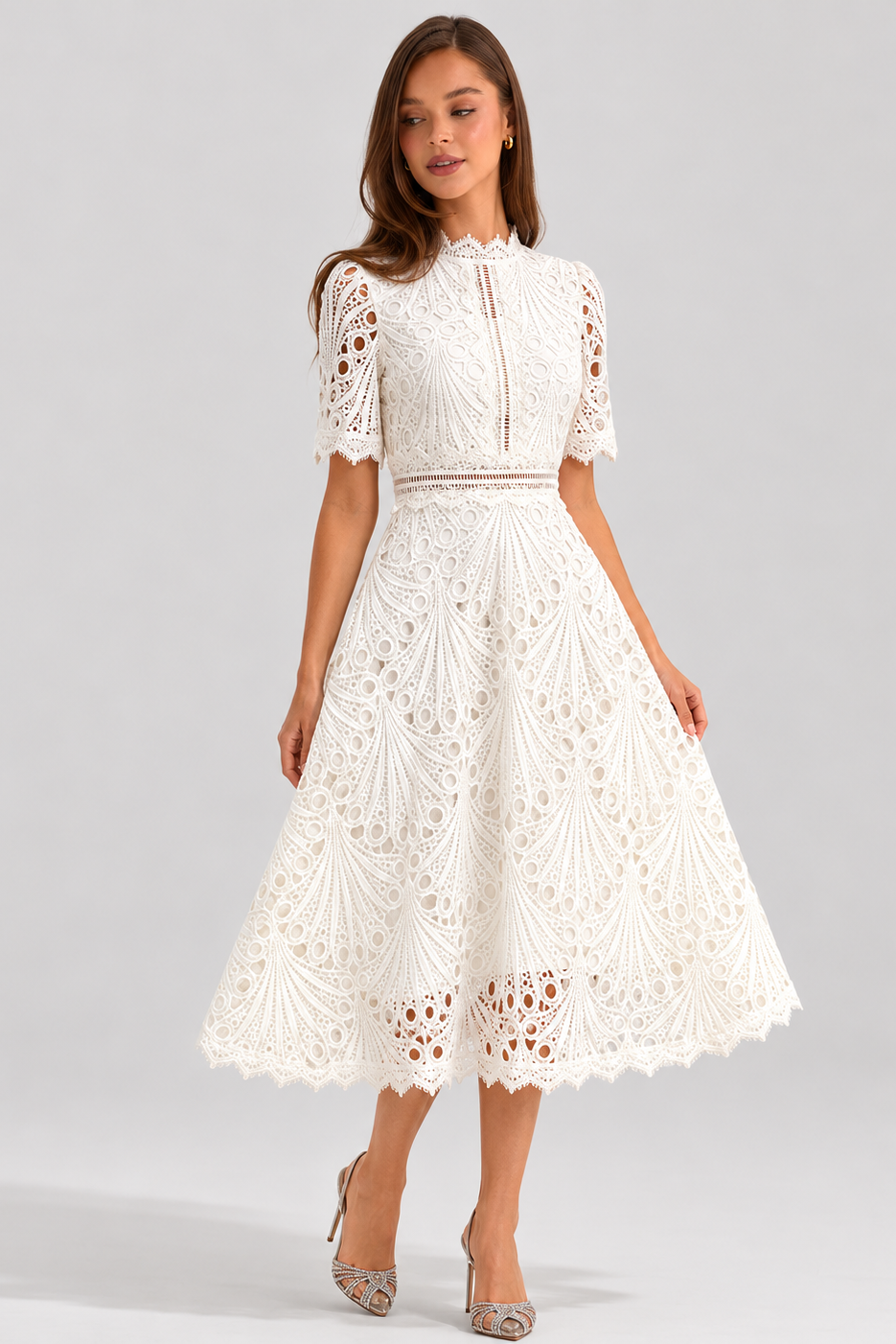Woman wearing a white lace dress on a gray background